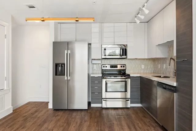 a kitchen with stainless steel appliances a refrigerator stove and sink