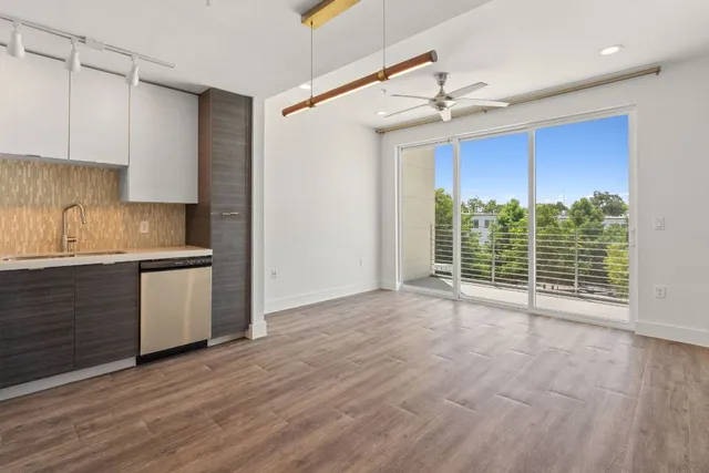 a view of a kitchen with wooden floor and a kitchen