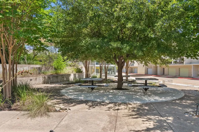 a row of palm trees in front of a house