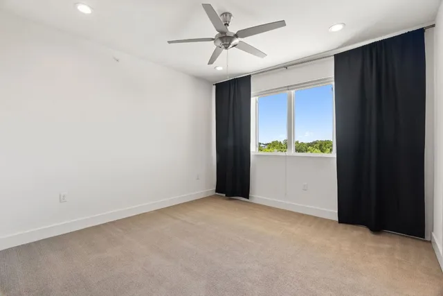 an empty room with closet and windows