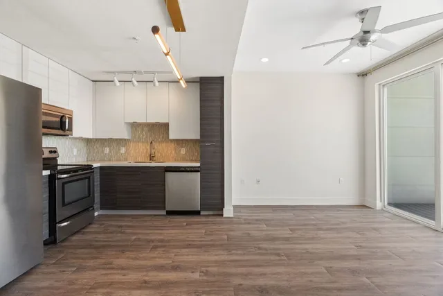 a kitchen with a refrigerator stove and sink