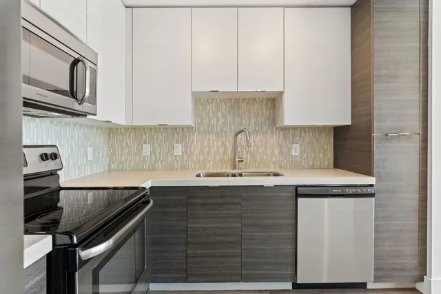 a kitchen with a sink cabinets and window