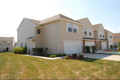 a view of a house with yard and garage