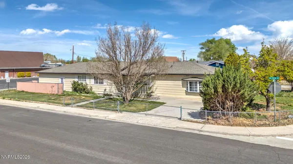a view of a house with a street and a yard