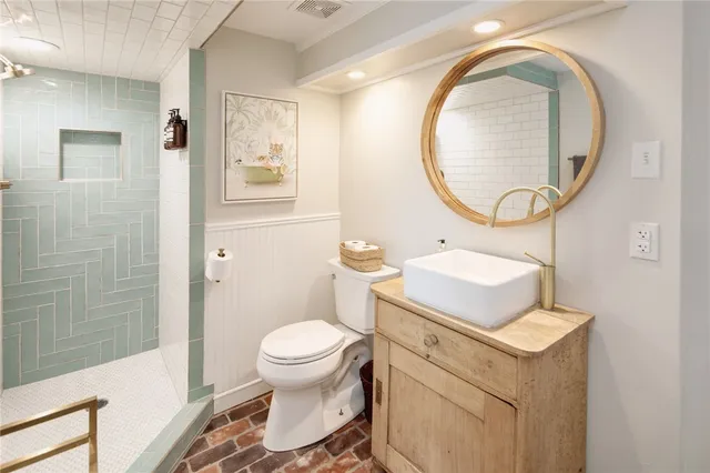 a bathroom with a sink toilet and a mirror