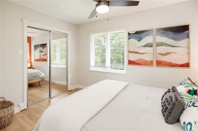 a bedroom with a bed and a painting on the wall