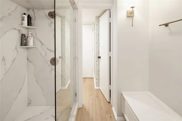 a bathroom with a bathtub and a shower