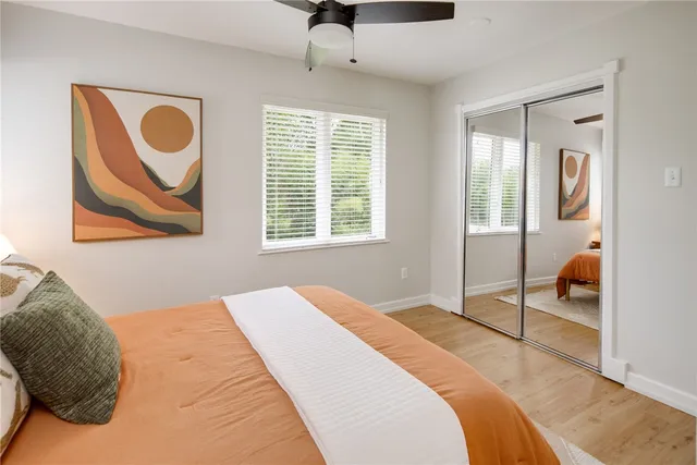 a bedroom with a bed and a painting on the wall