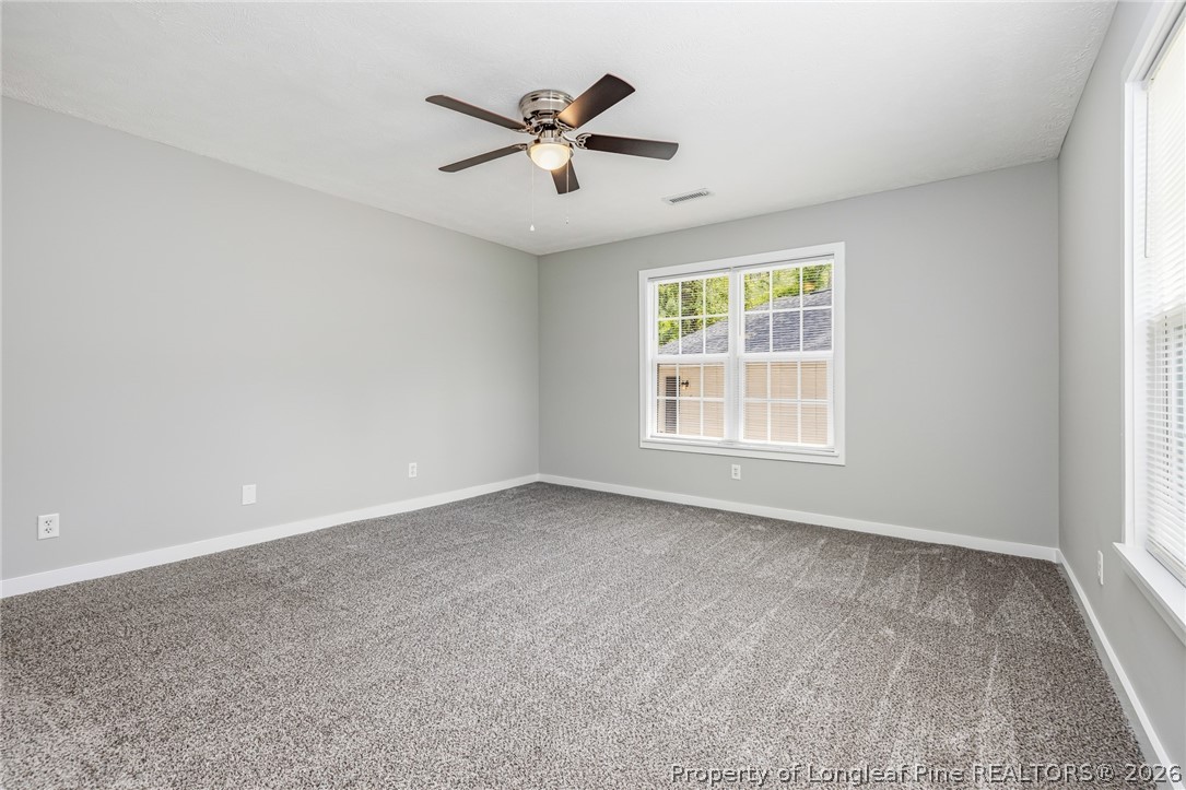3524 Pine Log Road Lumberton, NC 28360 - Photo 18 of 42 an empty room with ceiling fan and windows