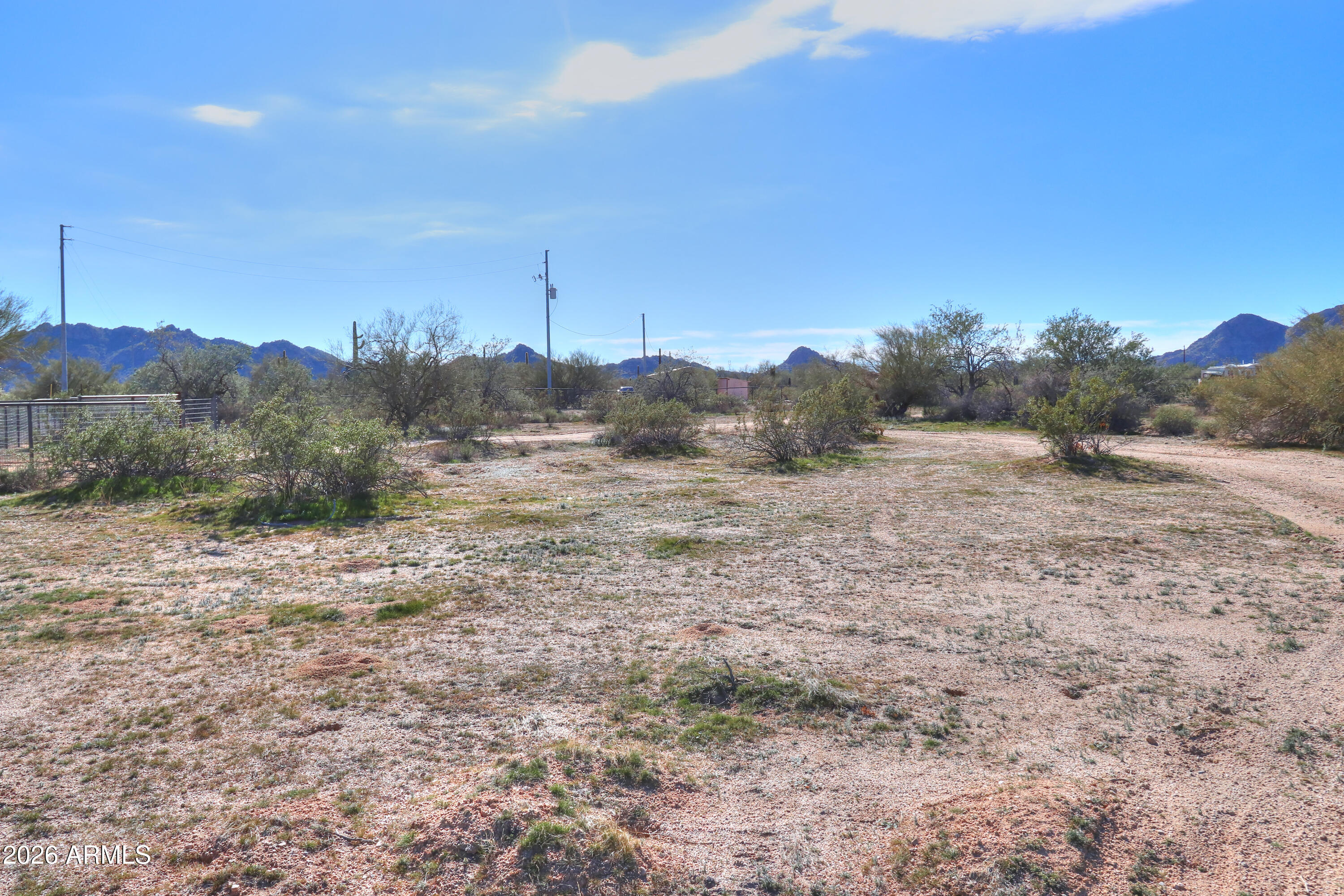 4 South Rincon Road, Unit 58 Maricopa, AZ 85139 - Photo 5 of 20 a view of a dry yard with trees in the background