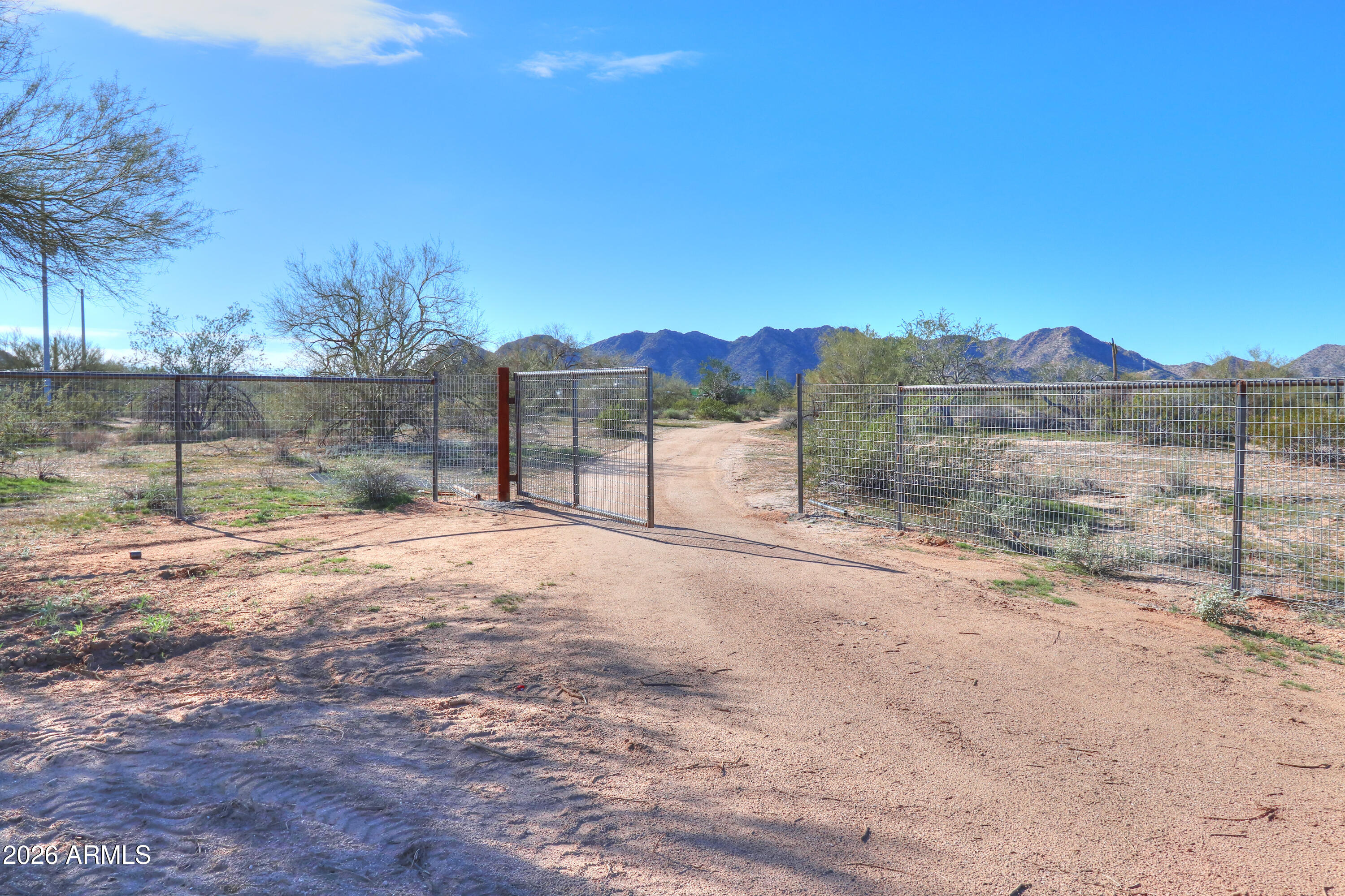 4 South Rincon Road, Unit 58 Maricopa, AZ 85139 - Photo 6 of 20 a view of a yard with a bench in front of house