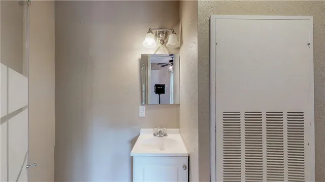 a bathroom with a sink a mirror and window