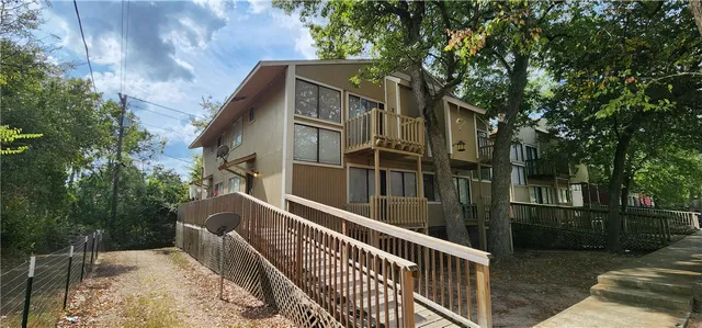 a view of a house with backyard and wooden