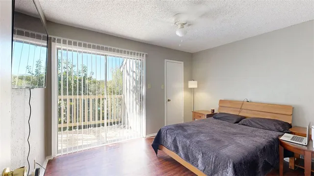 a living room with furniture and a painting on the wall