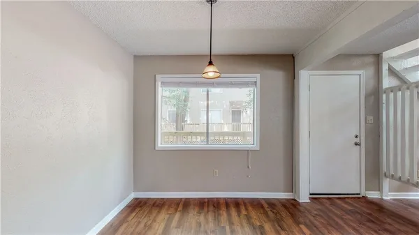 a window in an empty room with wooden floor