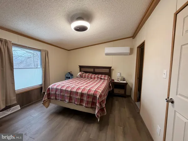 a bed sitting in a bedroom next to a window