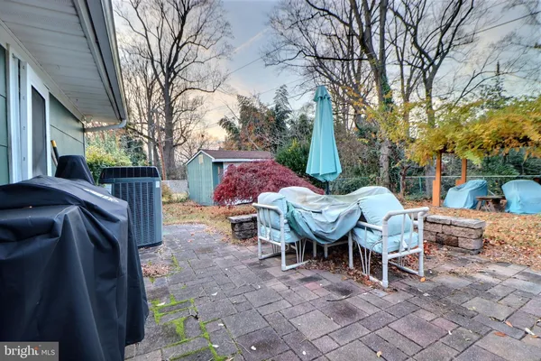 a view of a patio with a table chairs and a fire pit