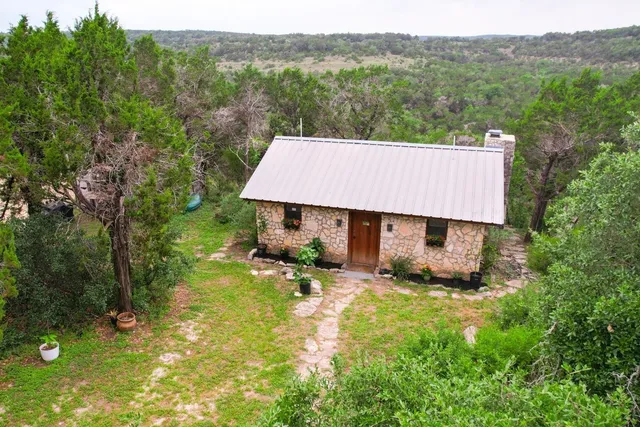 a view of a house with pool and a yard