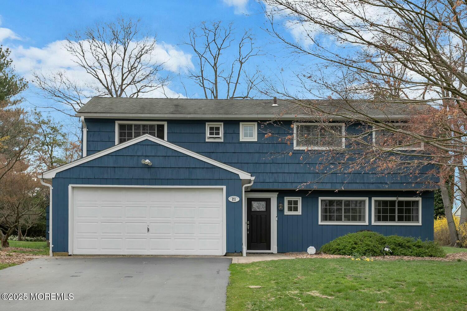 21 Judith Road Little Silver, NJ 07739 - Photo 1 of 48 a front view of a house with a yard and garage