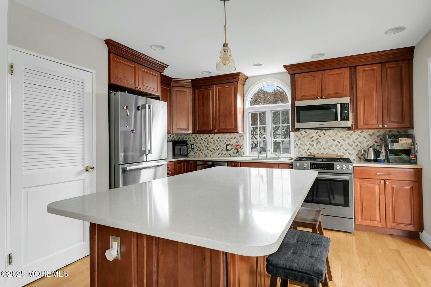 21 Judith Road Little Silver, NJ 07739 - Photo 11 of 48 a kitchen with stainless steel appliances granite countertop a sink refrigerator dining table and chairs