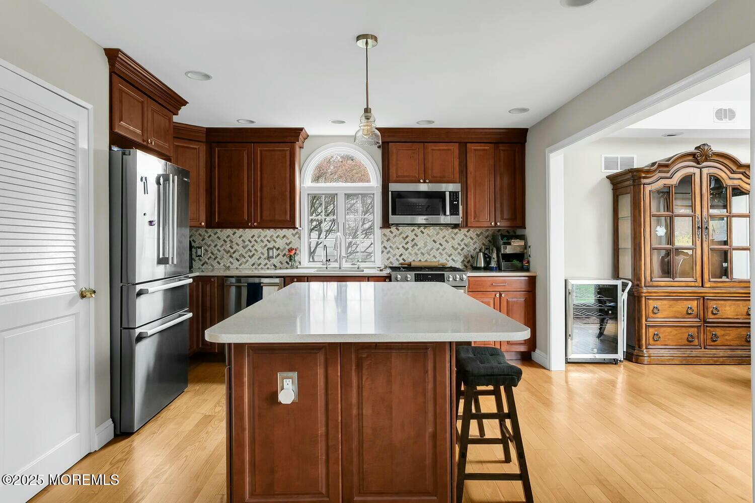 21 Judith Road Little Silver, NJ 07739 - Photo 10 of 48 a kitchen with stainless steel appliances granite countertop a refrigerator a stove and a sink with wooden floor