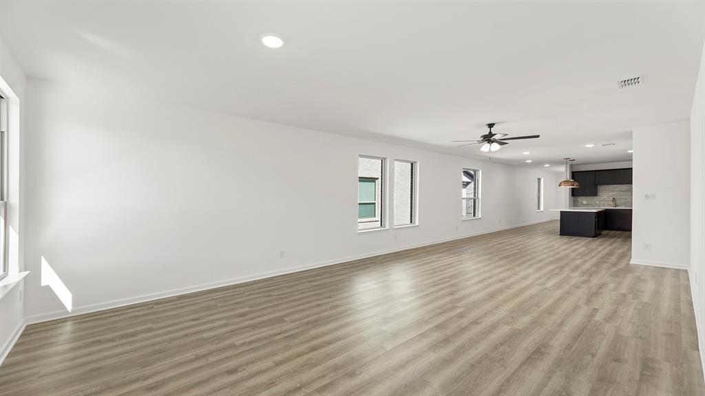 2516 YO Rnch Road Anna, TX 75409 - Photo 17 of 30 wooden floor in an empty room with a window