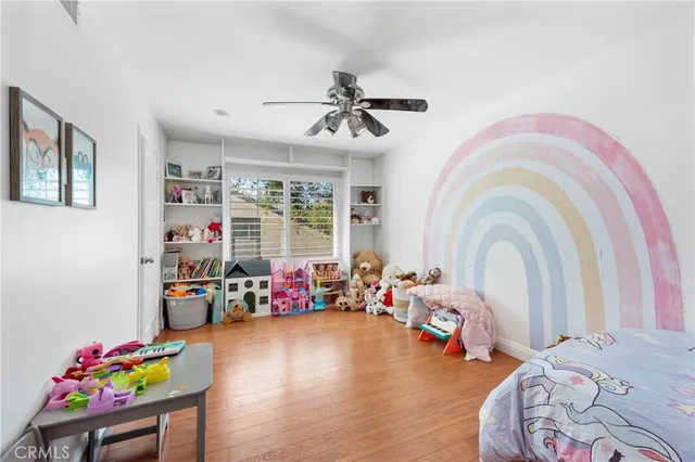a bedroom with bed and a chandelier