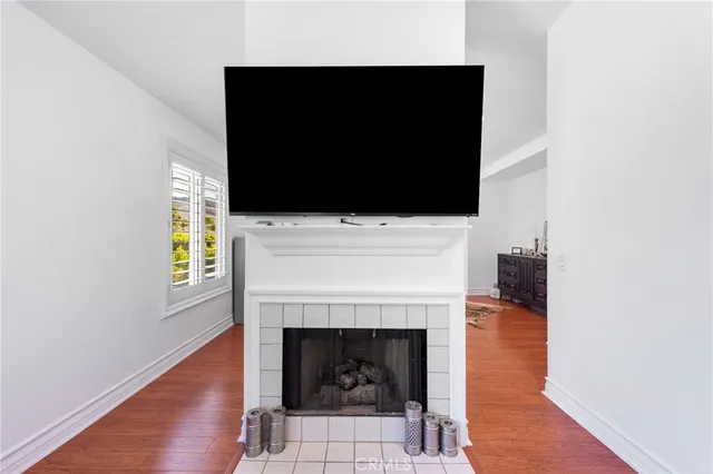a living room with a fireplace and a flat screen tv