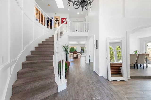 a view of entryway and hall with wooden floor