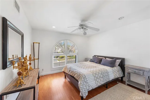 a bedroom with a bed table and window