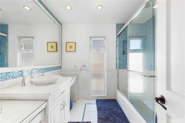 a bathroom with a sink a mirror and a shower