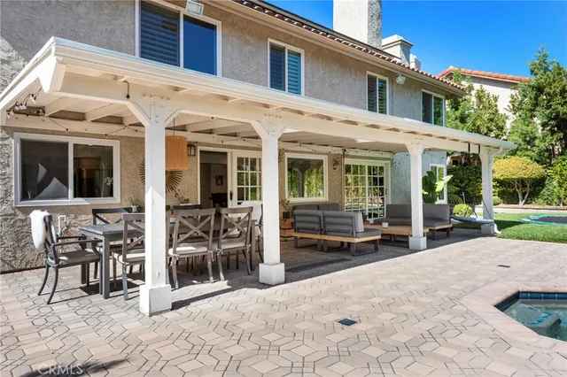 a view of a patio with table and chairs near a yard