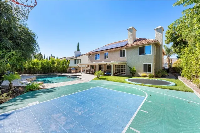a front view of a house with swimming pool having outdoor seating
