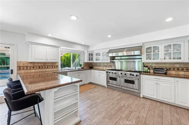 a kitchen with stainless steel appliances granite countertop a stove and a sink