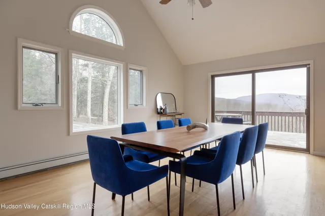 a view of a dining room with furniture a chandelier and wooden floor
