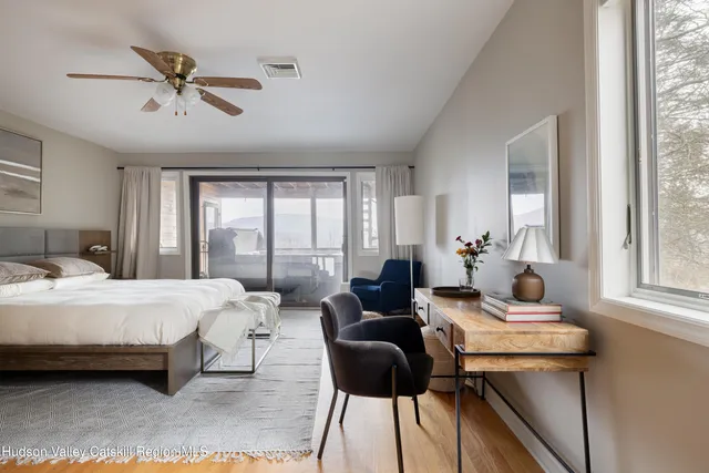 a bedroom with a bed and windows