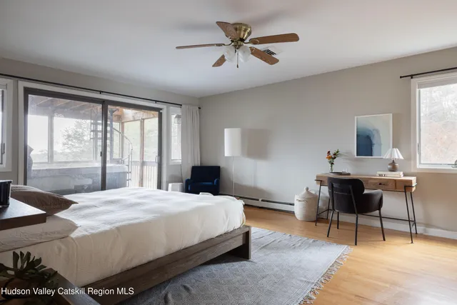 a bedroom with a bed a table and chair