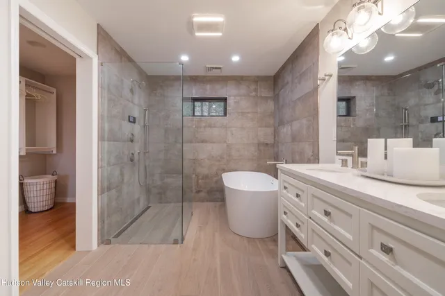 a spacious bathroom with a granite countertop sink a toilet and shower