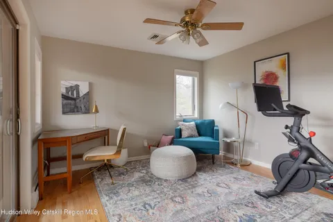 a bed sitting in a bedroom next to a window