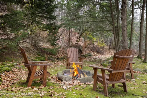 a view of a chairs and table in the backyard