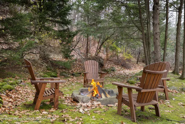 a view of a chairs and table in the backyard