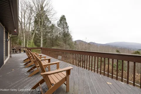 a view of a roof deck with wooden floor and fence