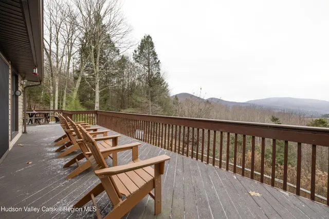 a view of a roof deck with wooden floor and fence