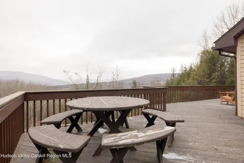 a view of a roof deck with furniture