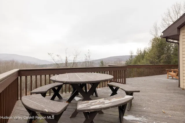 a view of a roof deck with furniture