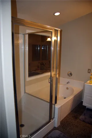 a bathroom with a bathtub a toilet a sink and mirror