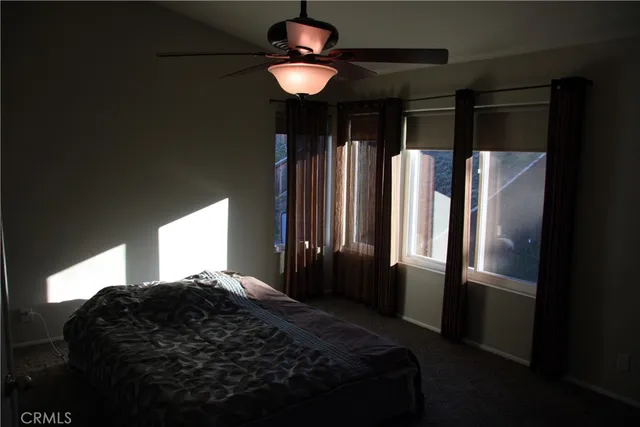 a bedroom with a large bed and a chandelier