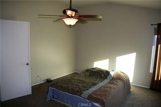 a bed sitting in a bedroom next to a window