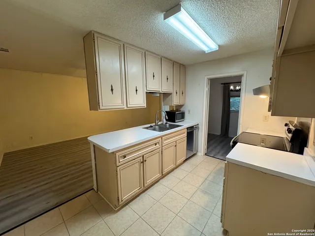 a kitchen that has a sink and a stove