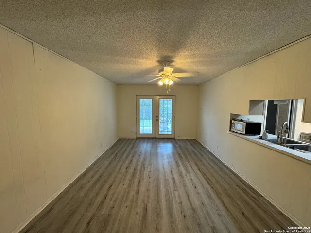 a view of a room with wooden floor and window